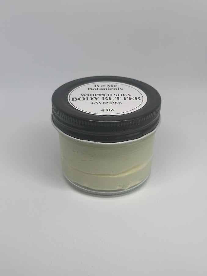 A four ounce glass jar of whipped lavender shea butter with the lid on